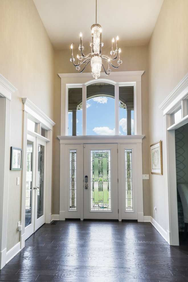 Mid-sized transitional foyer in Cleveland with beige walls, dark hardwood floors, a single front door and a white front door.