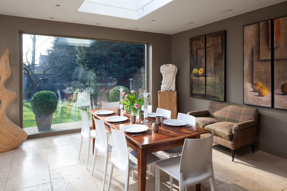 Inspiration for an eclectic dining room in Gloucestershire with brown walls and travertine floors.