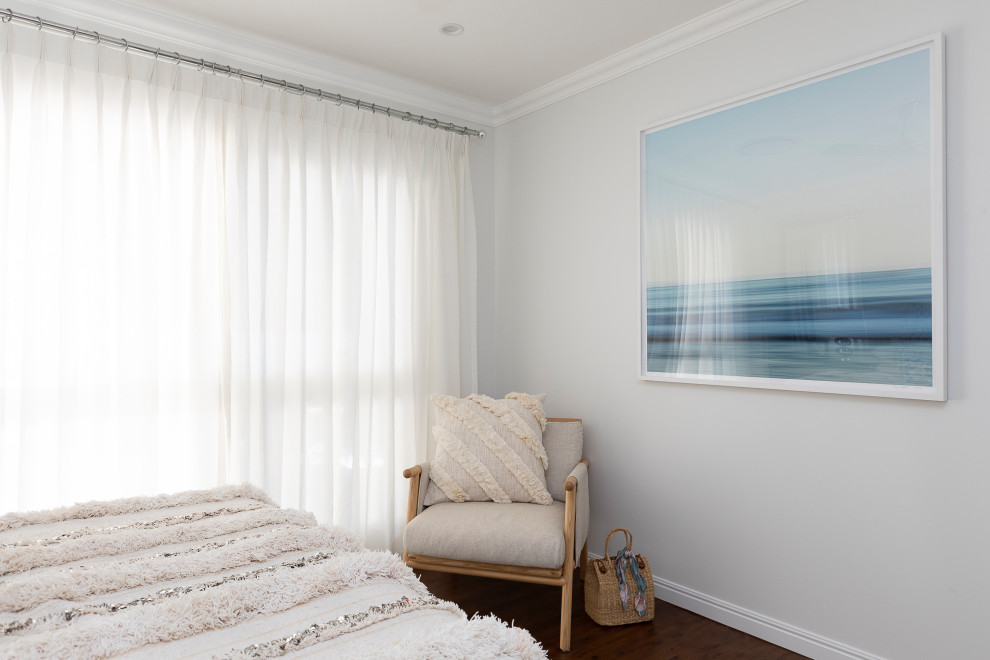 Mid-sized beach style master bedroom in Brisbane with white walls, dark hardwood floors and brown floor.