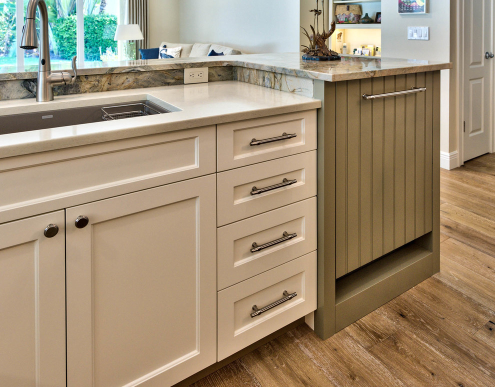 Mid-sized transitional u-shaped medium tone wood floor open concept kitchen photo in Miami with an undermount sink, shaker cabinets, white cabinets, granite countertops, multicolored backsplash, stone slab backsplash, stainless steel appliances and an island