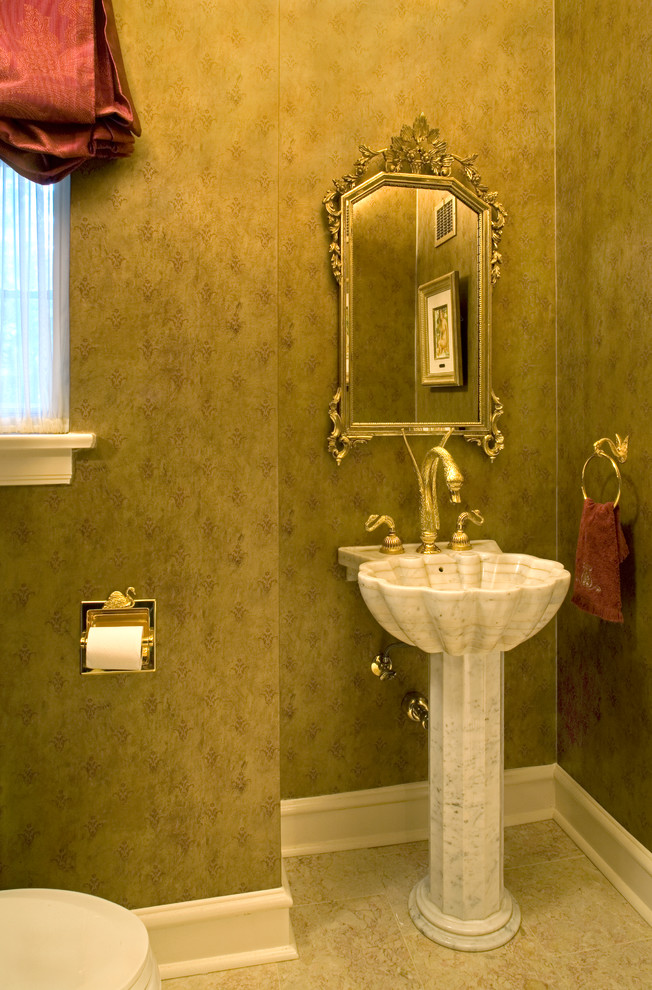 Inspiration for a small traditional powder room in Chicago with a pedestal sink and green walls.