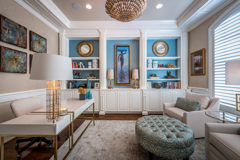 This is an example of a mid-sized transitional study room in Houston with beige walls, dark hardwood floors, a freestanding desk and brown floor.