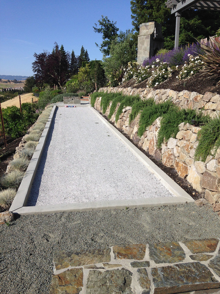 Inspiration for an expansive traditional sloped full sun outdoor sport court for spring in San Francisco with gravel and a retaining wall.