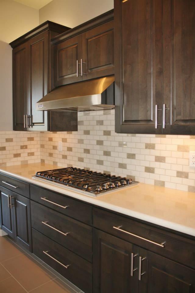 Large transitional u-shaped porcelain tile eat-in kitchen photo in Phoenix with an undermount sink, raised-panel cabinets, dark wood cabinets, quartz countertops, beige backsplash, stone tile backsplash, stainless steel appliances and an island