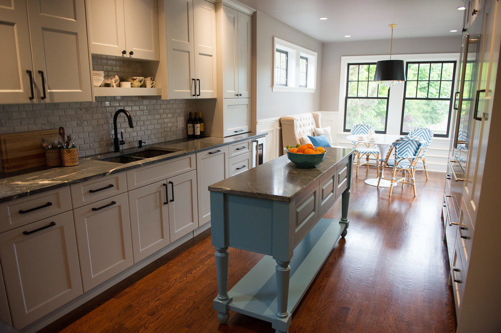 Eat-in kitchen - mid-sized transitional l-shaped dark wood floor eat-in kitchen idea with an undermount sink, gray cabinets, soapstone countertops, gray backsplash, stone tile backsplash, stainless steel appliances, an island and shaker cabinets