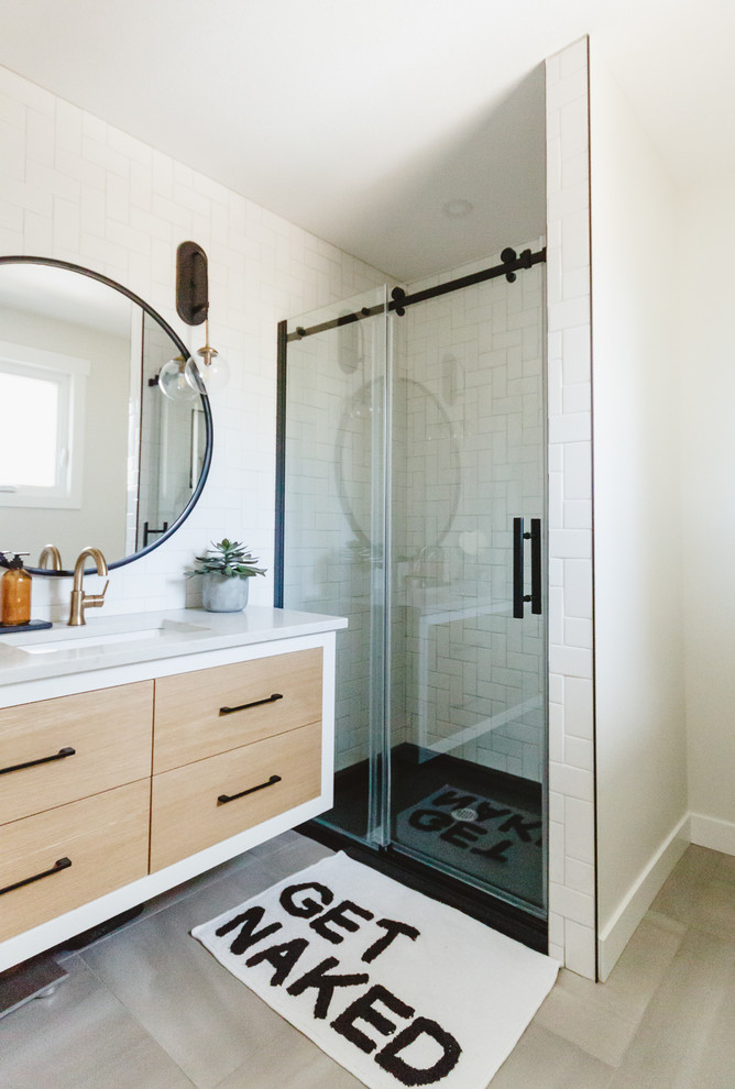 Design ideas for a small transitional master bathroom in Other with flat-panel cabinets, light wood cabinets, an open shower, a one-piece toilet, white tile, ceramic tile, white walls, vinyl floors, an undermount sink, engineered quartz benchtops, grey floor, a sliding shower screen and white benchtops.