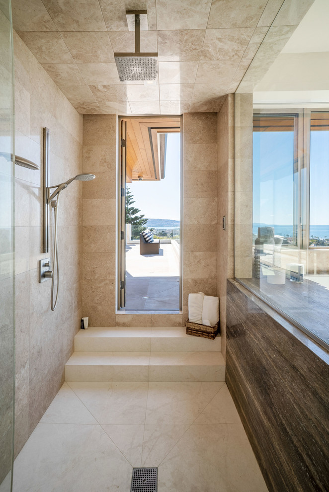 This is an example of a large contemporary master bathroom in Los Angeles with flat-panel cabinets, brown cabinets, a hot tub, an open shower, beige tile, marble, beige walls, limestone floors, granite benchtops, white floor, an open shower and multi-coloured benchtops.