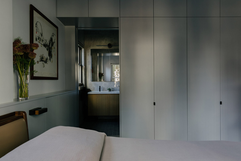 This is an example of a mid-sized modern bedroom in New York.