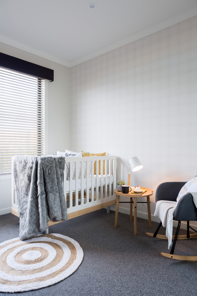 Transitional gender-neutral nursery in Melbourne with grey walls, carpet and grey floor.