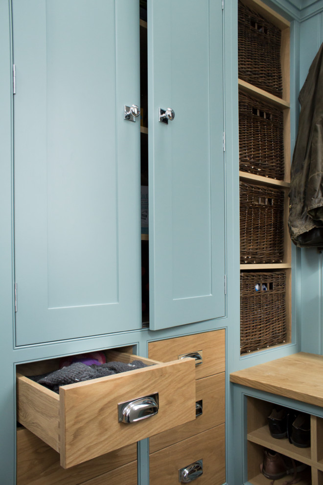 This is an example of a small traditional l-shaped utility room in Manchester with shaker cabinets, blue cabinets, white walls, limestone floors and grey floor.