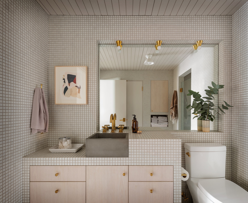 Photo of an industrial bathroom in Portland with flat-panel cabinets, light wood cabinets, white tile, mosaic tile, a vessel sink, tile benchtops and white benchtops.