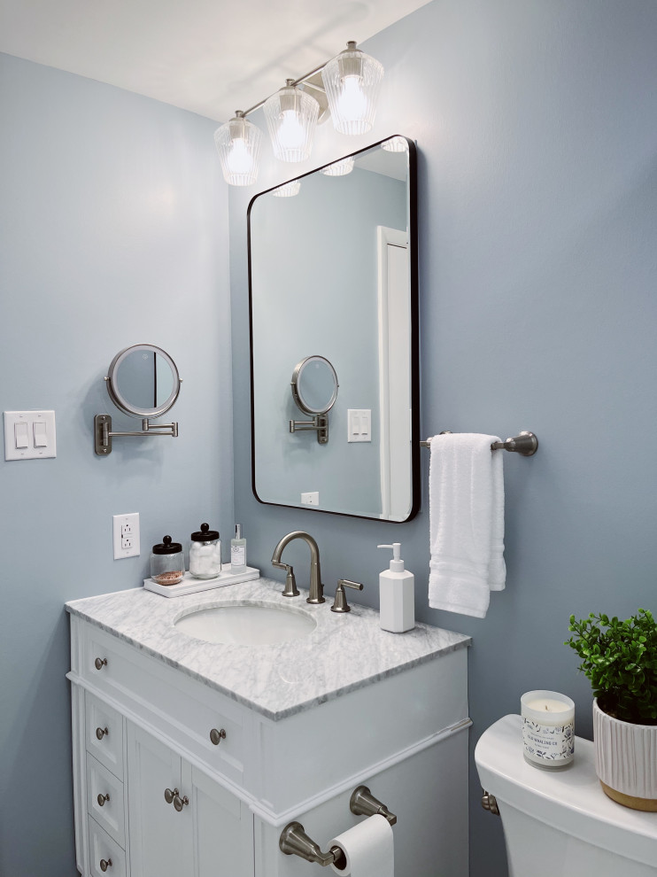 Inspiration for a small transitional kids' white tile and porcelain tile porcelain tile, white floor and single-sink alcove shower remodel with shaker cabinets, white cabinets, a two-piece toilet, blue walls, an undermount sink, marble countertops, gray countertops and a freestanding vanity