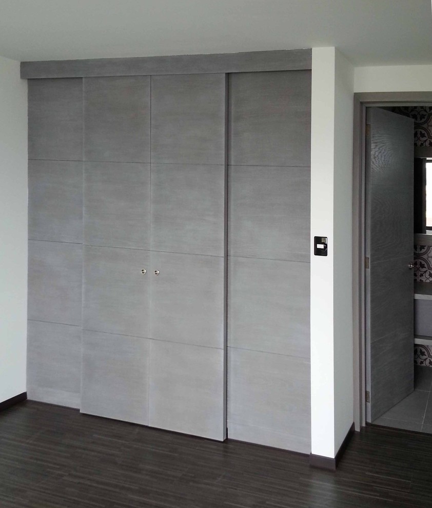 Mid-sized modern men's walk-in wardrobe in Other with recessed-panel cabinets, grey cabinets and vinyl floors.