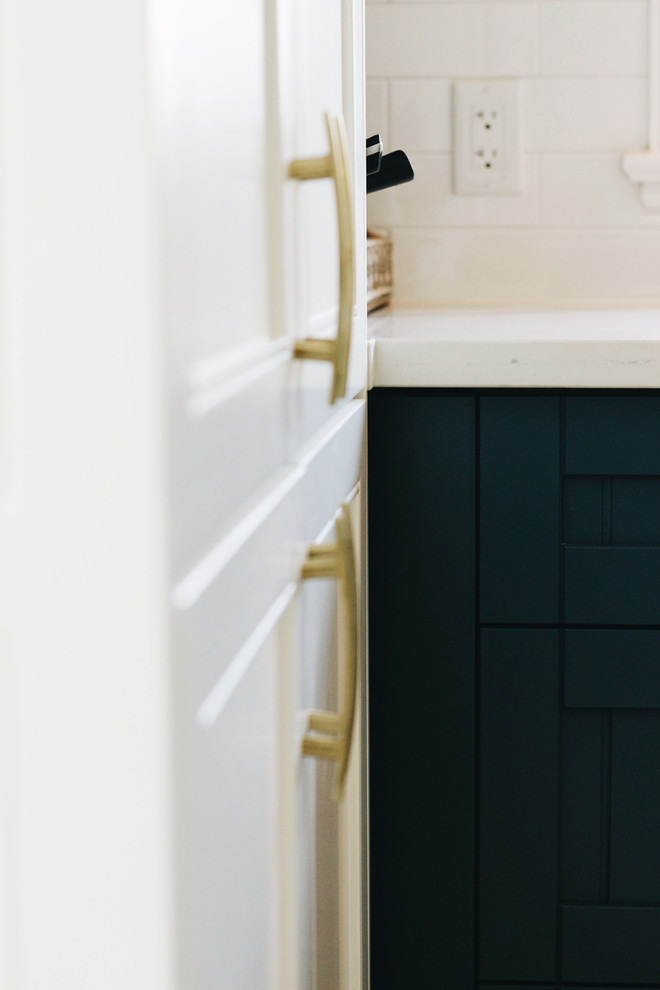 Example of a mid-sized transitional u-shaped porcelain tile and multicolored floor home design design in Toronto with a farmhouse sink, beaded inset cabinets, blue cabinets, quartzite countertops, white backsplash, ceramic backsplash, stainless steel appliances, no island and multicolored countertops
