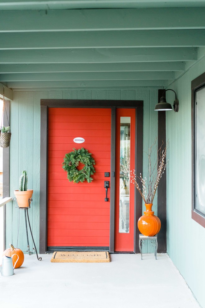 Design ideas for a large eclectic front door in Other with a single front door, a red front door, green walls, concrete floors and grey floor.