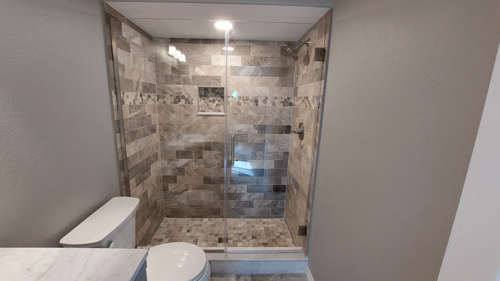 This is an example of a medium sized classic shower room bathroom in Denver with shaker cabinets, grey cabinets, a walk-in shower, a two-piece toilet, brown tiles, marble tiles, grey walls, terrazzo flooring, a submerged sink, marble worktops, grey floors, a hinged door, white worktops, a wall niche, a single sink and a freestanding vanity unit.