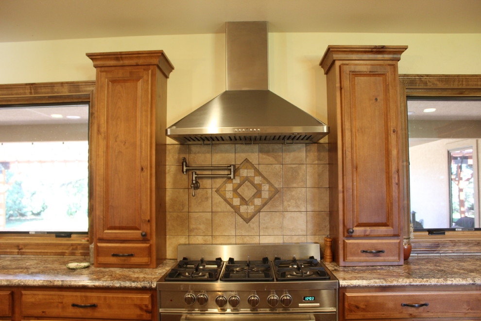 Inspiration for a large rustic l-shaped ceramic tile and beige floor open concept kitchen remodel in Denver with a drop-in sink, raised-panel cabinets, medium tone wood cabinets, laminate countertops, beige backsplash, ceramic backsplash, stainless steel appliances, an island and beige countertops
