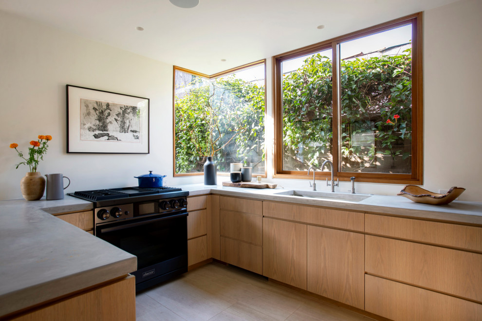 Photo of a small contemporary u-shaped separate kitchen in Los Angeles with an undermount sink, granite benchtops, window splashback, stainless steel appliances, a peninsula, brown floor, flat-panel cabinets, medium hardwood floors, medium wood cabinets and grey benchtop.