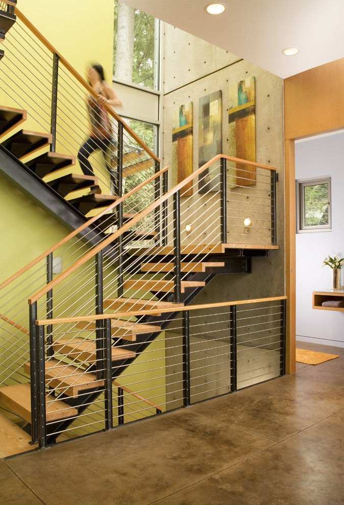 Photo of a contemporary staircase in Seattle with open risers and cable railing.
