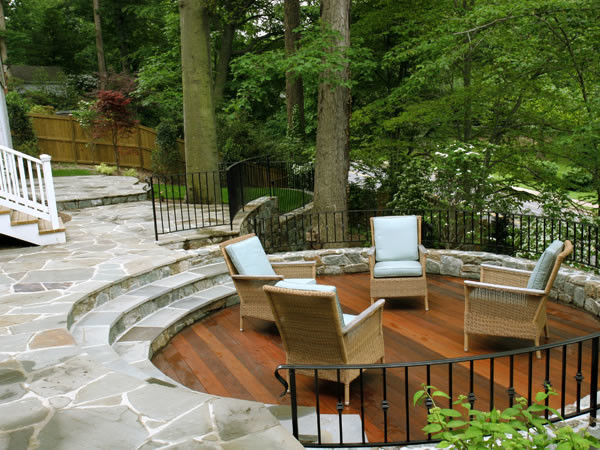 Photo of a large contemporary patio in DC Metro with natural stone pavers and no cover.