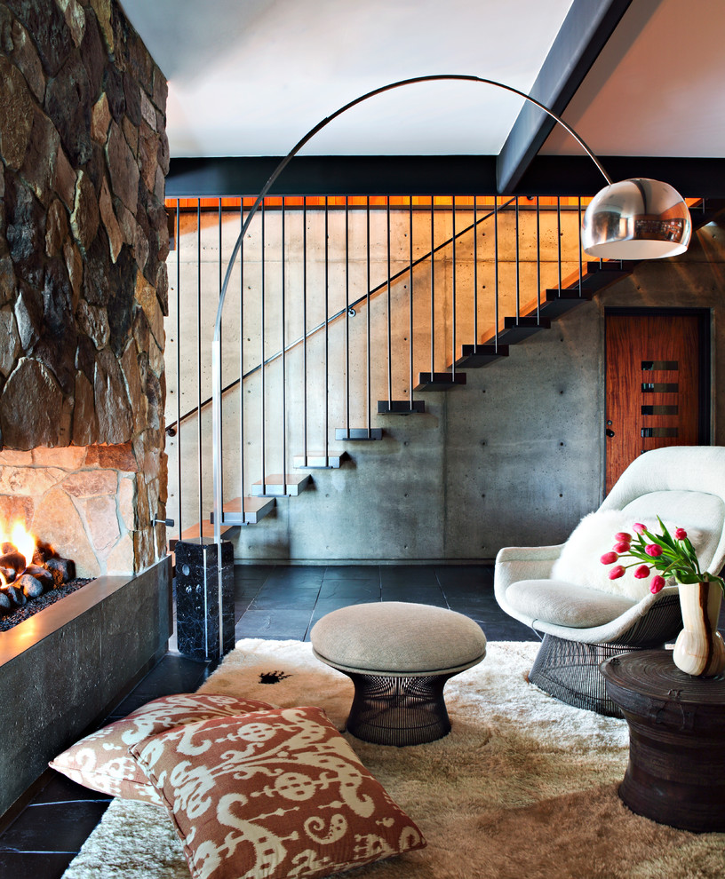 Midcentury open concept living room in Los Angeles with a standard fireplace, a stone fireplace surround and no tv.