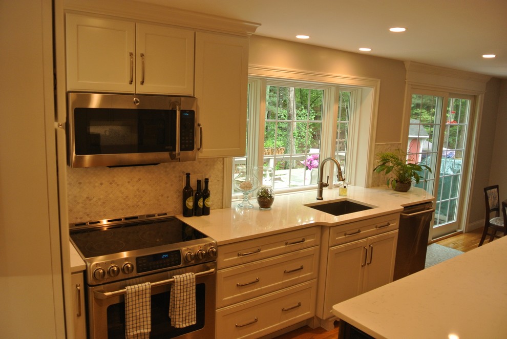 Transitional medium tone wood floor eat-in kitchen photo in Boston with an undermount sink, shaker cabinets, quartz countertops, beige backsplash, mosaic tile backsplash, stainless steel appliances, an island and white countertops