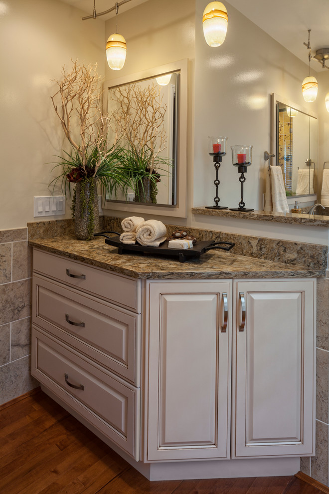 This is an example of a mid-sized traditional master bathroom in Cincinnati with raised-panel cabinets, white cabinets, multi-coloured tile, beige tile, engineered quartz benchtops, an alcove shower, white walls, an undermount sink, a one-piece toilet, ceramic tile, ceramic floors, beige floor and a hinged shower door.