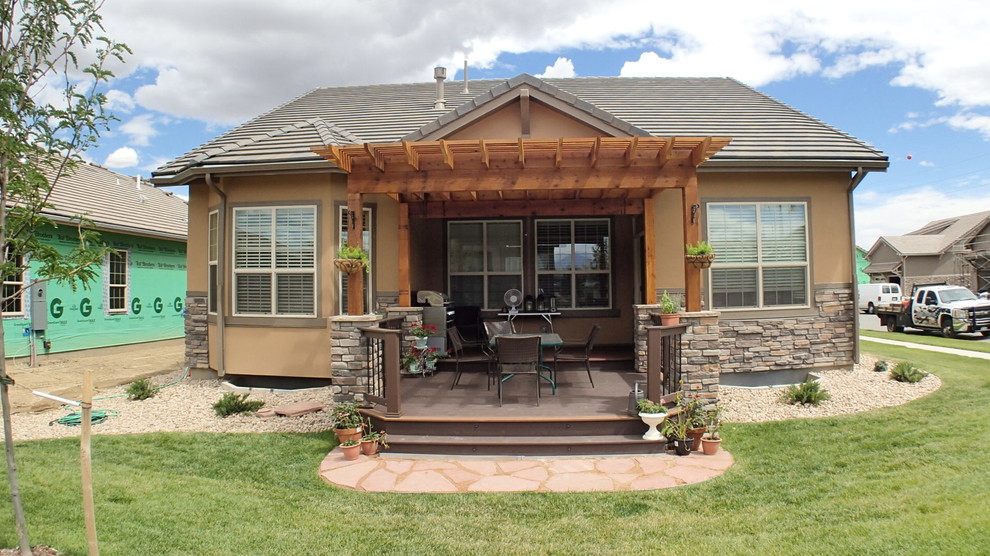 Inspiration for a small timeless backyard deck remodel in Denver with a pergola