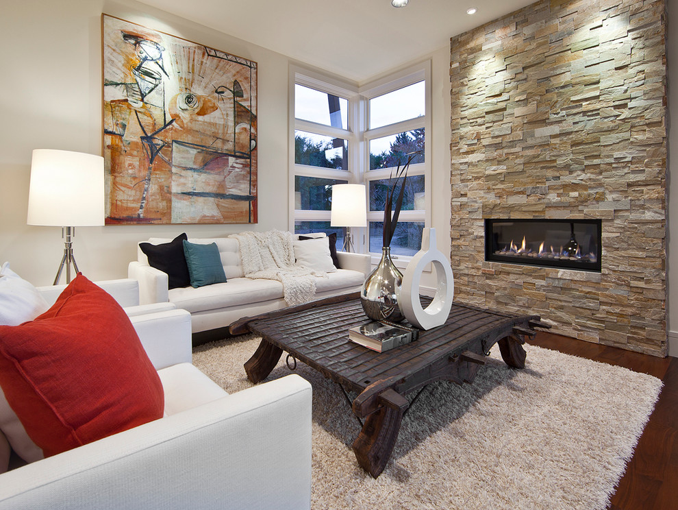 Contemporary living room in Seattle with a ribbon fireplace, a stone fireplace surround, no tv, white walls, medium hardwood floors and brown floor.