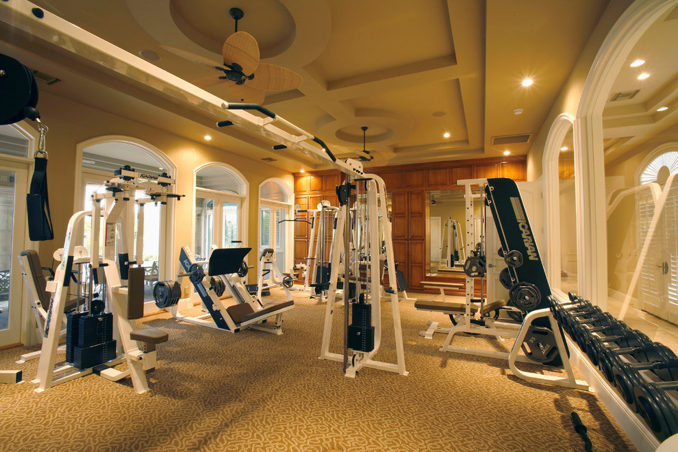 Inspiration for a large traditional home weight room in Las Vegas with beige walls and carpet.