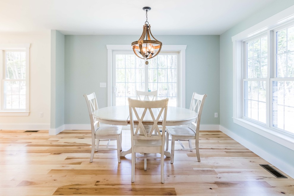 Photo of a small country dining room in Portland Maine with green walls, light hardwood floors and brown floor.