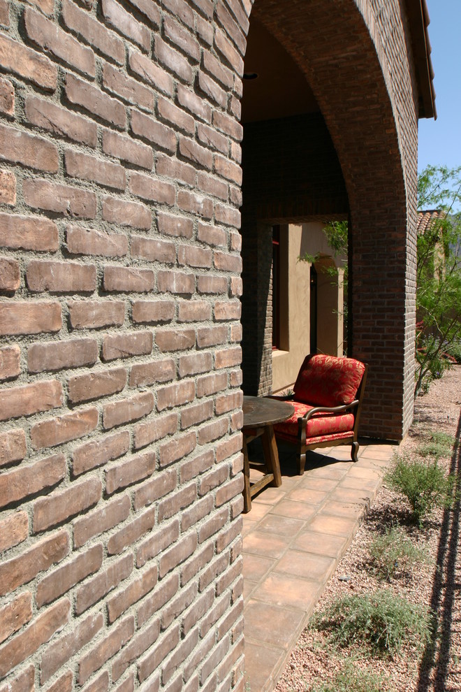 Inspiration for a mid-sized rustic courtyard tile deck remodel in Phoenix