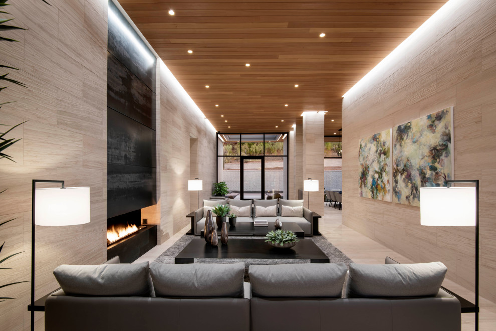 This is an example of an expansive contemporary open plan living room in Phoenix with limestone flooring, a wall mounted tv, a ribbon fireplace and a wood ceiling.