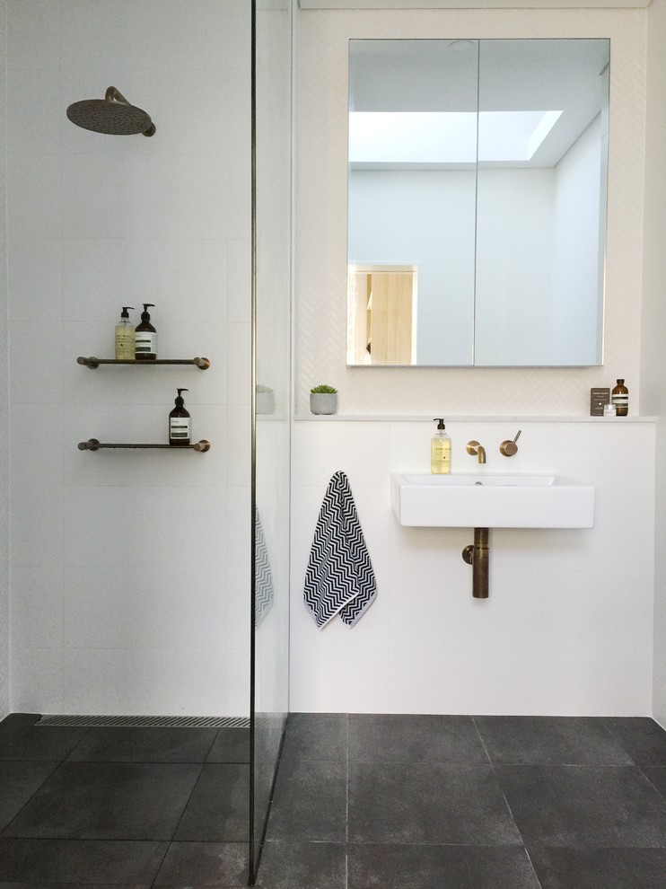Large modern bathroom in Sydney with a wall-mount sink, marble benchtops, a wall-mount toilet, white tile, mosaic tile, white walls, concrete floors and a curbless shower.