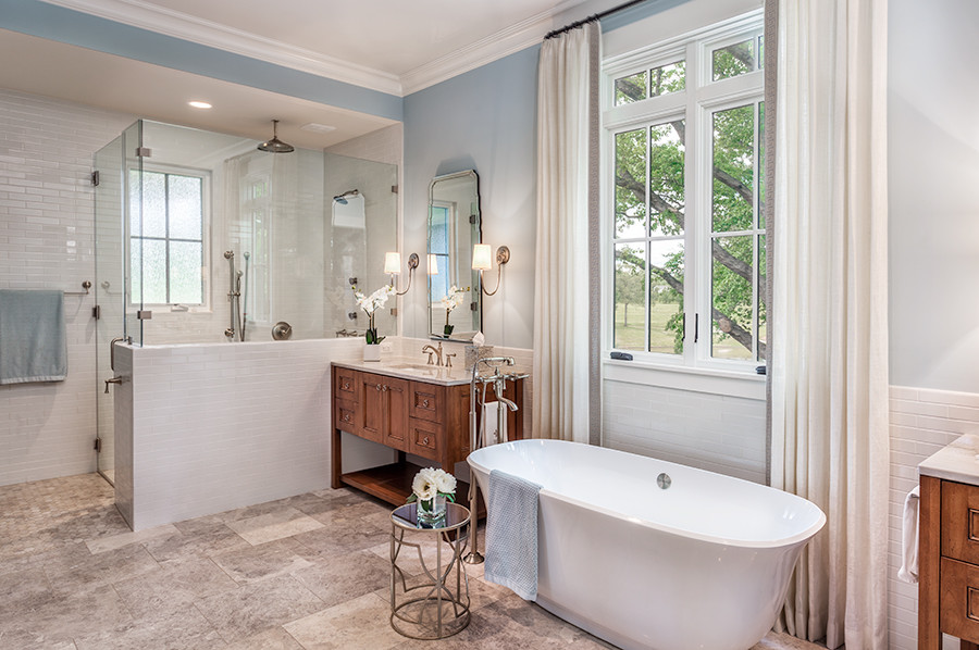 Inspiration for a large country master bathroom in Other with furniture-like cabinets, medium wood cabinets, a freestanding tub, a curbless shower, white tile, subway tile, blue walls, marble floors, an undermount sink, granite benchtops, a one-piece toilet, multi-coloured floor and a hinged shower door.