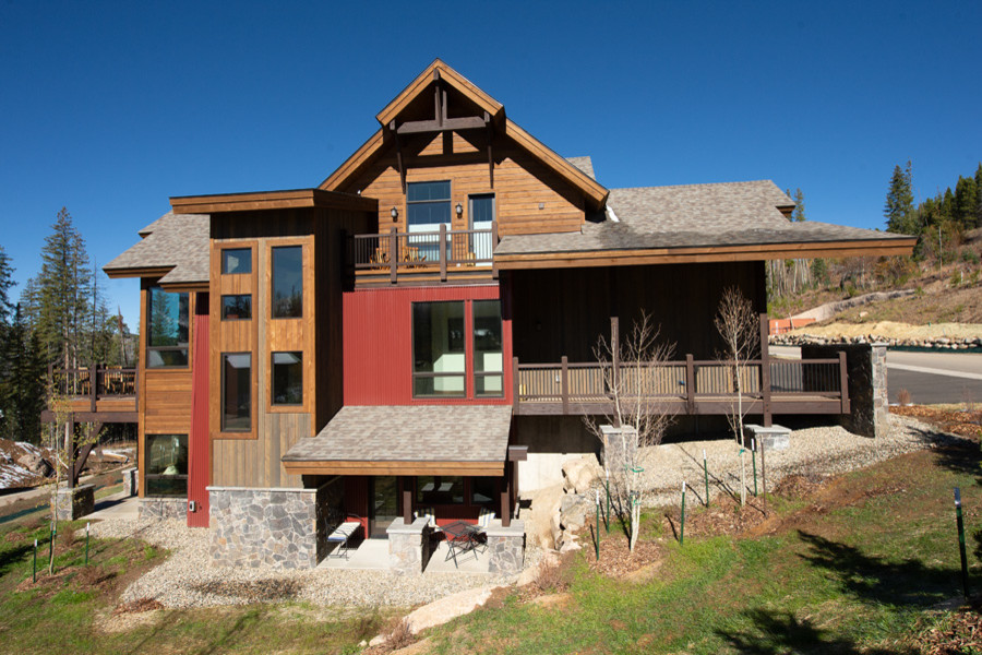 Photo of a large country two-storey duplex exterior in Denver with mixed siding.