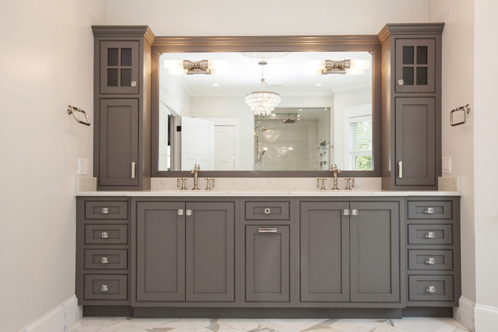 Inspiration for a large transitional master bathroom in Boston with beaded inset cabinets, grey cabinets, a freestanding tub, a curbless shower, a two-piece toilet, grey walls, marble floors, an undermount sink, granite benchtops, white floor and a hinged shower door.