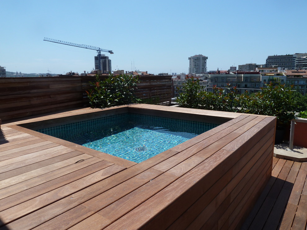 This is an example of a small contemporary rooftop custom-shaped aboveground pool in Barcelona with decking.
