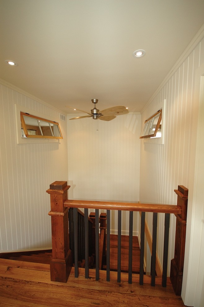 This is an example of a mid-sized metal l-shaped staircase in Toronto with wood railing.