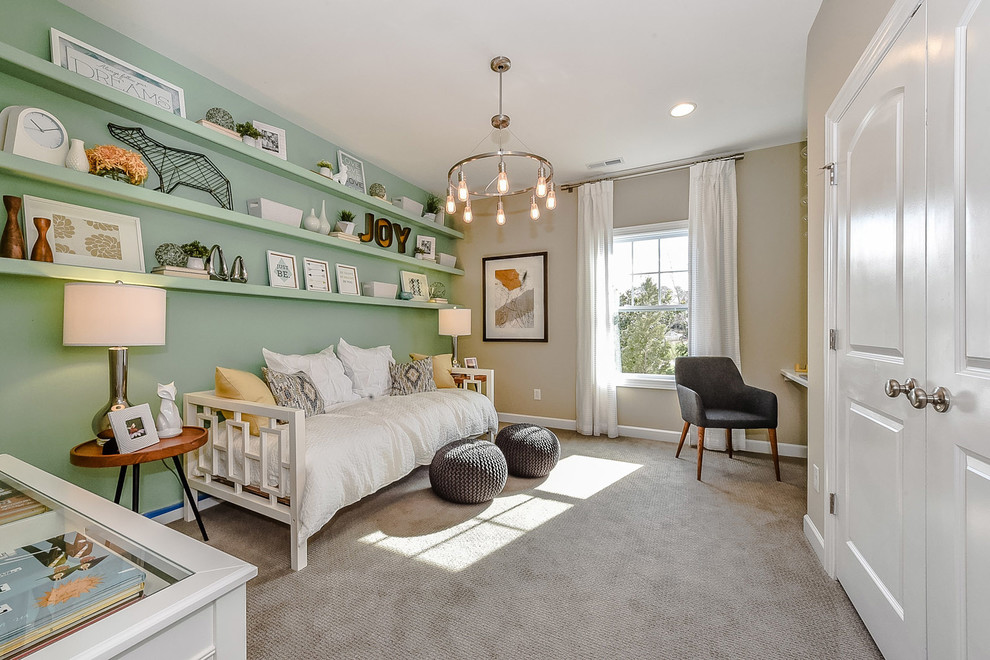 This is an example of a mid-sized transitional guest bedroom in Charlotte with green walls, carpet and grey floor.