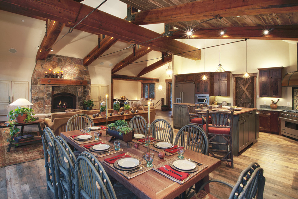 Great room - large rustic medium tone wood floor and brown floor great room idea in Orange County with beige walls and no fireplace