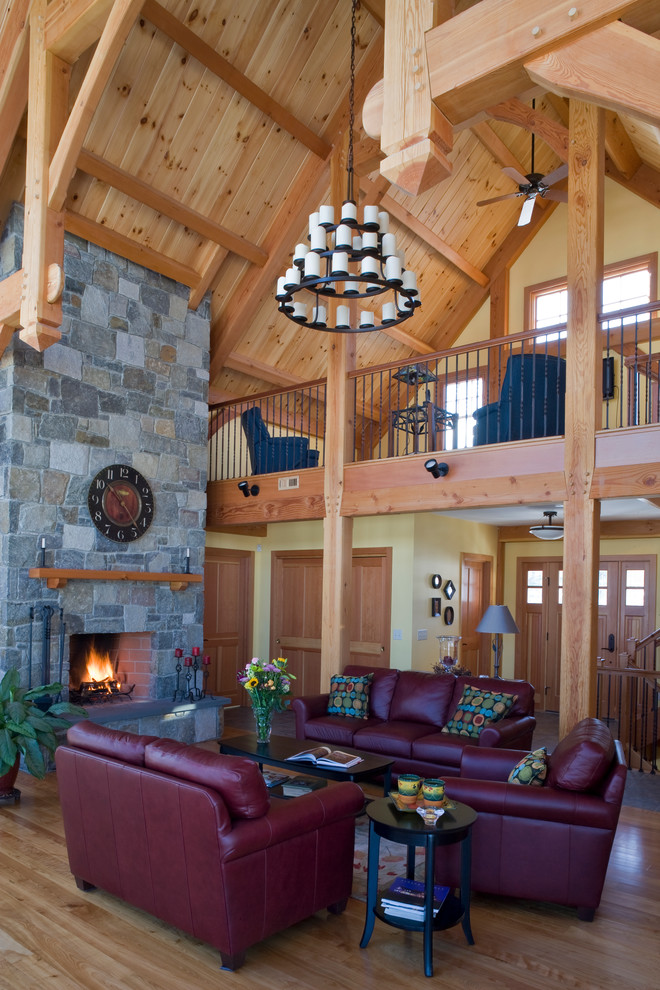 Design ideas for an expansive country open concept living room in Burlington with a stone fireplace surround, medium hardwood floors and a standard fireplace.