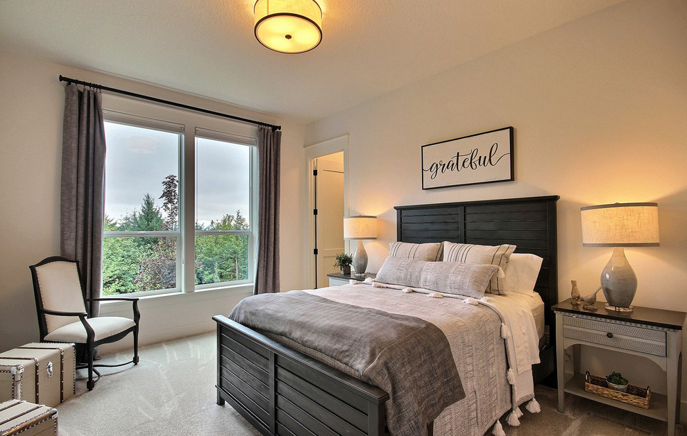 This is an example of an expansive country guest bedroom in Portland with beige walls, carpet and beige floor.