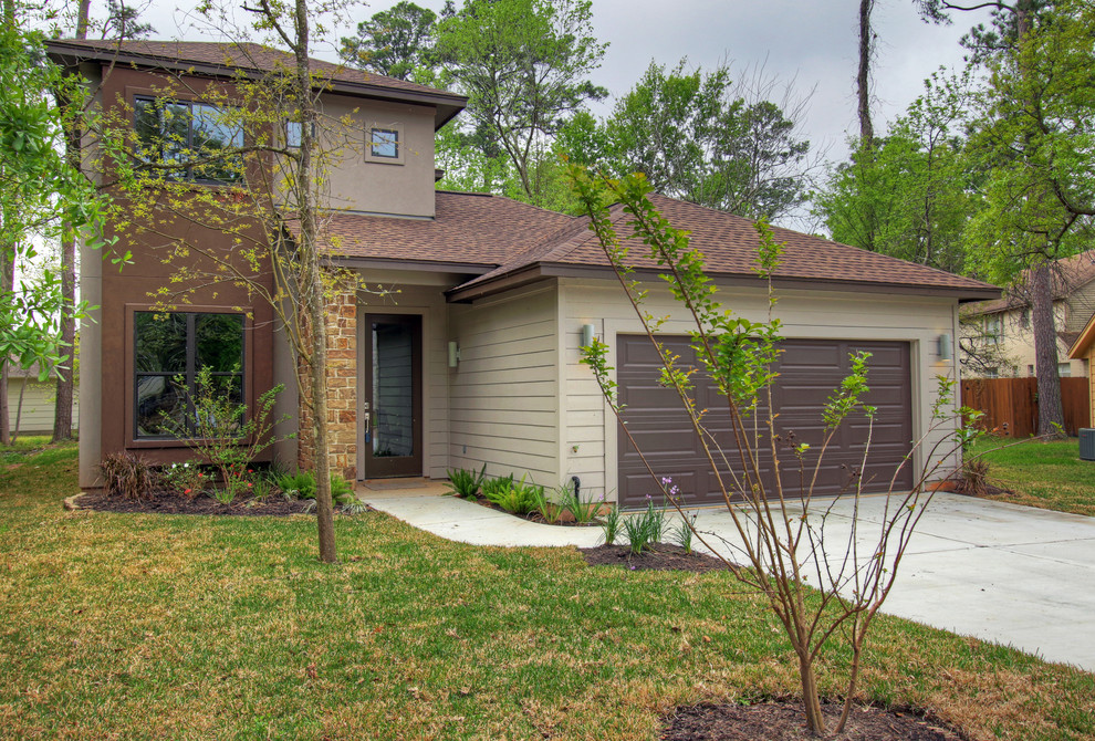 Photo of a mid-sized contemporary two-storey beige exterior in Houston with mixed siding and a hip roof.