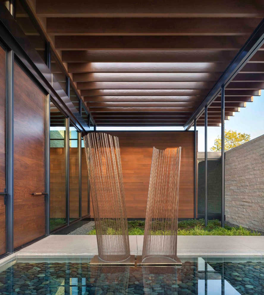 Inspiration for a contemporary partial sun garden in Denver with with pond.