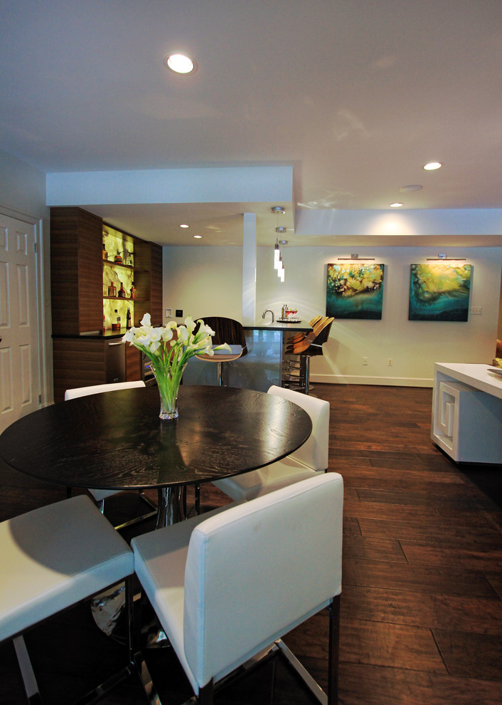Design ideas for a large contemporary walk-out basement in DC Metro with white walls and dark hardwood floors.