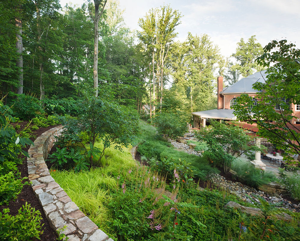 Design ideas for a mid-sized traditional backyard garden in DC Metro with natural stone pavers.