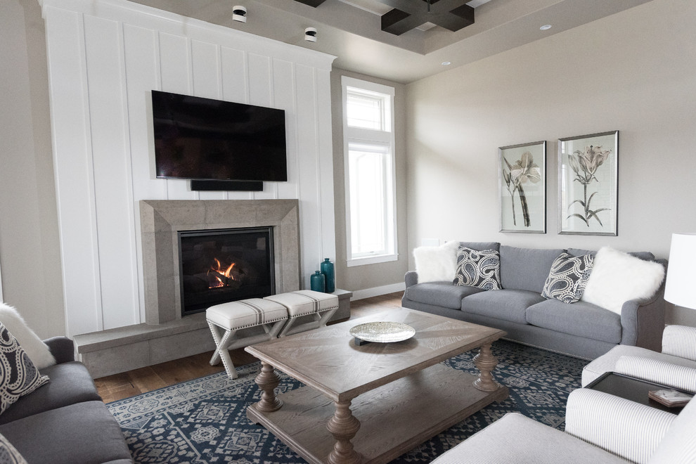Photo of a large beach style enclosed family room in Denver with grey walls, dark hardwood floors, a standard fireplace, a concrete fireplace surround, a wall-mounted tv and brown floor.