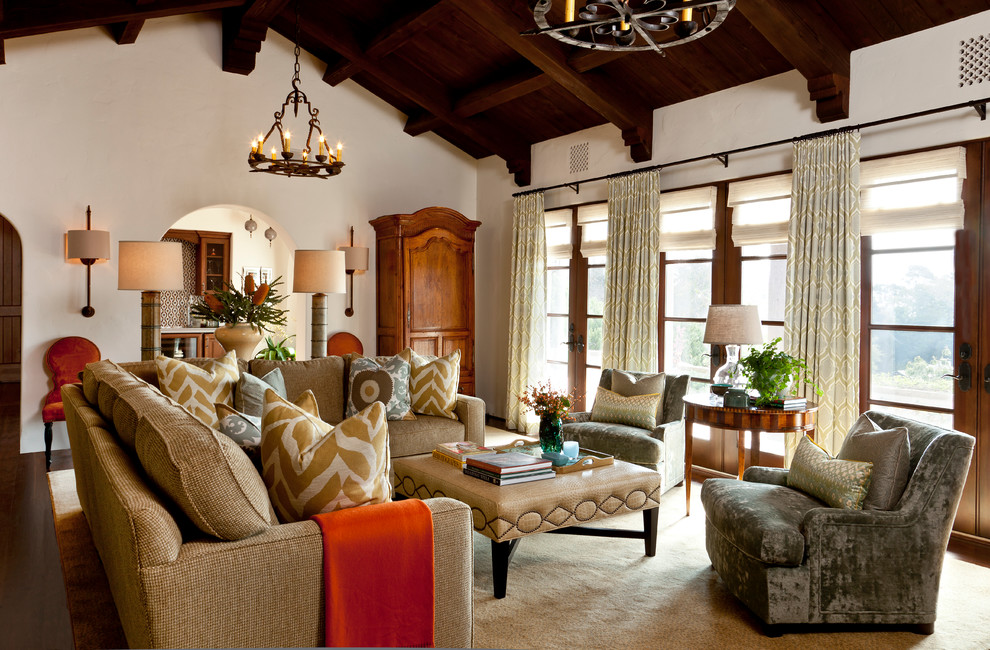 This is an example of a mid-sized mediterranean enclosed living room in Santa Barbara with beige walls, dark hardwood floors, no fireplace and no tv.
