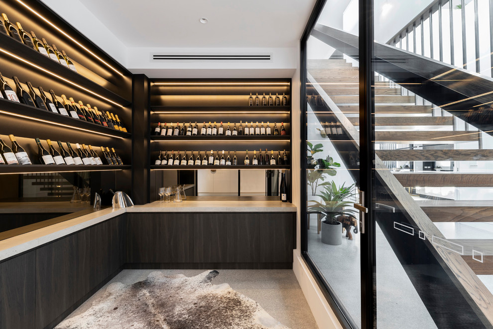 Design ideas for a large contemporary wine cellar in Melbourne with concrete floors, display racks and grey floor.